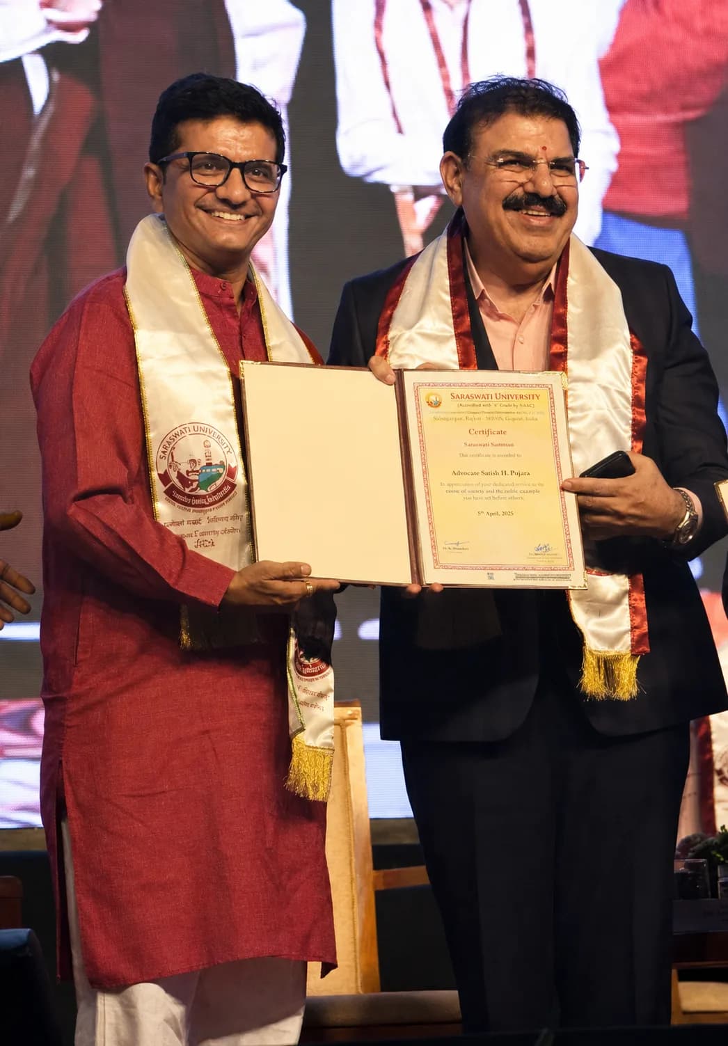 Satish H. Pujara receiving an award on stage
